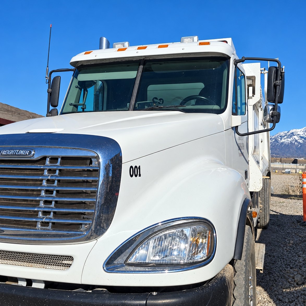 White Freightliner work truck from the front corner with a clean two-piece windshield