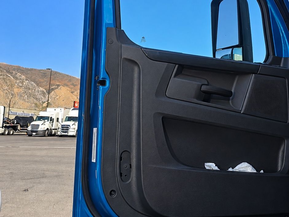 Blue semi truck door standing open with its new door glass in place